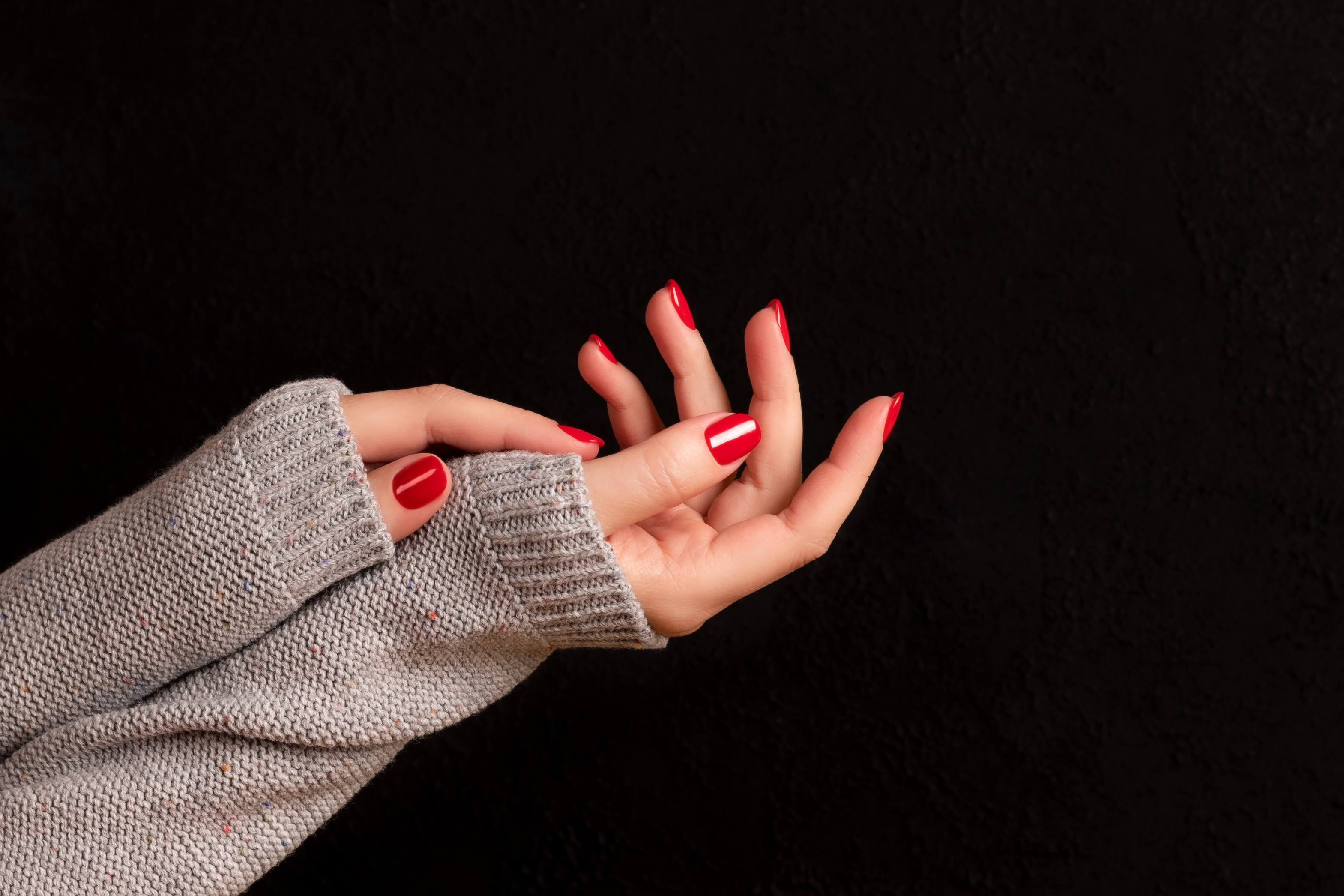 Female hands with beautiful manicure - red nails